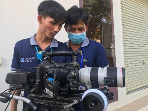 Two students behind the camera